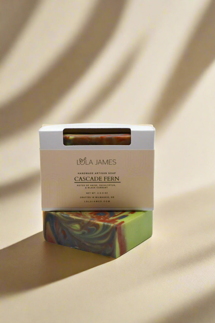 Colorful soap bar with a Lola James packaging on a neutral background