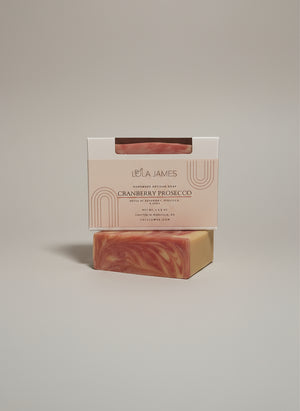 Bar of soap with packaging labeled 'Lola James' on a white background