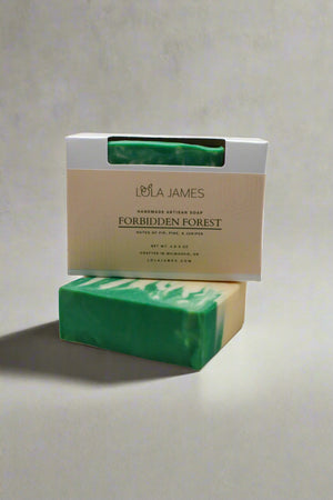 Green soap bar with Lola James packaging on a beige background