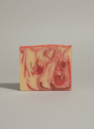 Swirled pink and cream soap bar on a white background