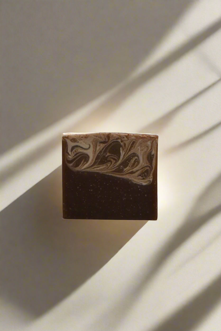 Brown soap bar with marbled design on a white background