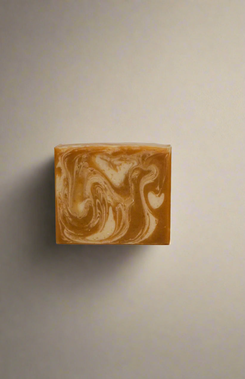 Marbled gold and white soap bar on a white background