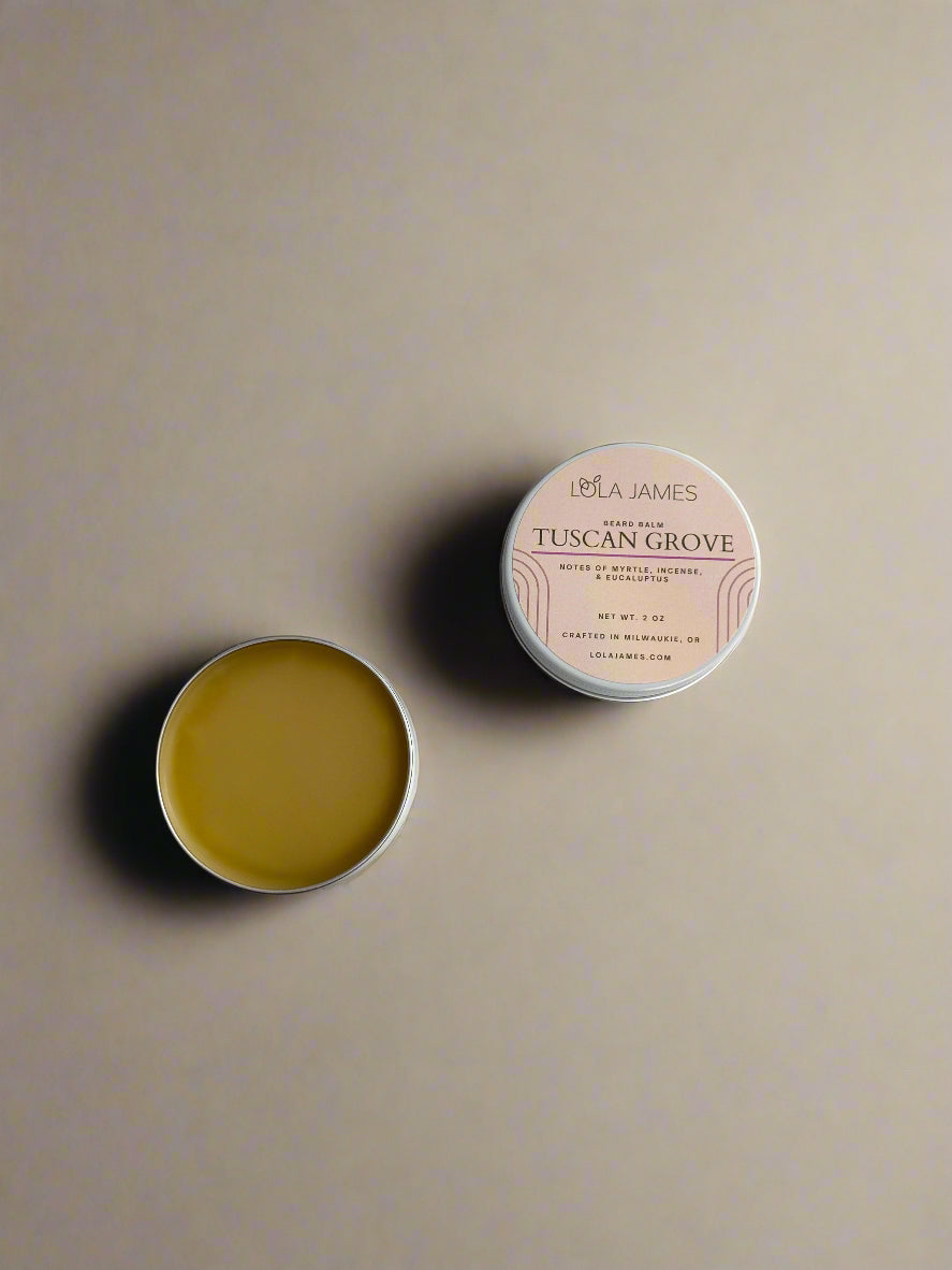 2 white Tuscan Grove Beard Balm tins on a beige background.